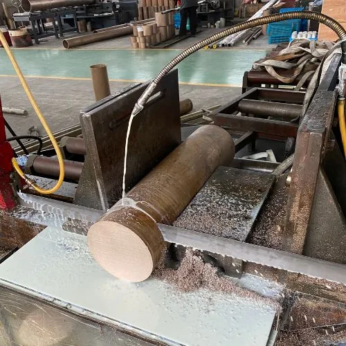 Copper nickel bar stock being cut to blank size on a saw