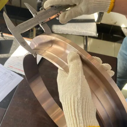 Dimensional measurement of a copper nickel flange with a caliper