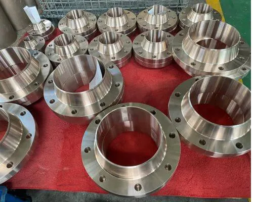 Copper nickel weld neck flanges laid out together